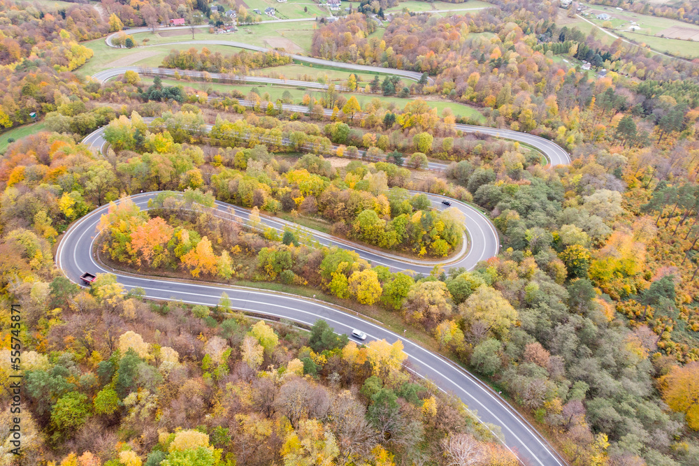 Cars drive curvy road in Wujskie, Poland, aerial view Cars drive curvy road in Wujskie, Poland, aerial view