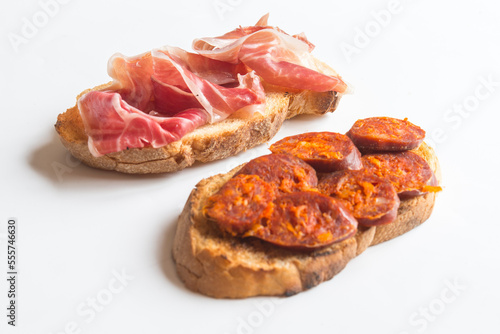 Slice of bread with chorizo and serrano ham