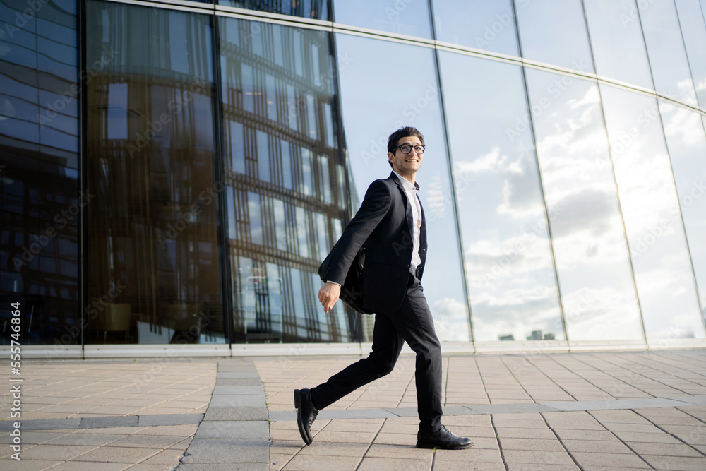 A successful businessman man goes to the office, dressed in a business suit, holding a briefcase. A successful businessman man goes to the office, dressed in a business suit, holding a briefcase.