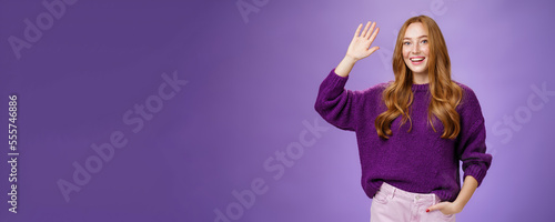 High five mate, hello. Portrait of friendly and excited charming kind redhead girl in sweater raising hand and waving in hi gesture, greeting best friend and smiling broadly as pleased meet