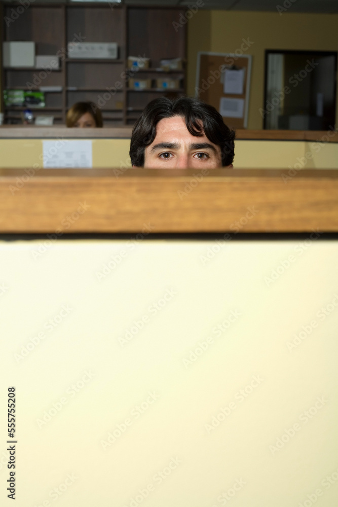 Man Peeking Over Cubicle Wall Stock Photo | Adobe Stock