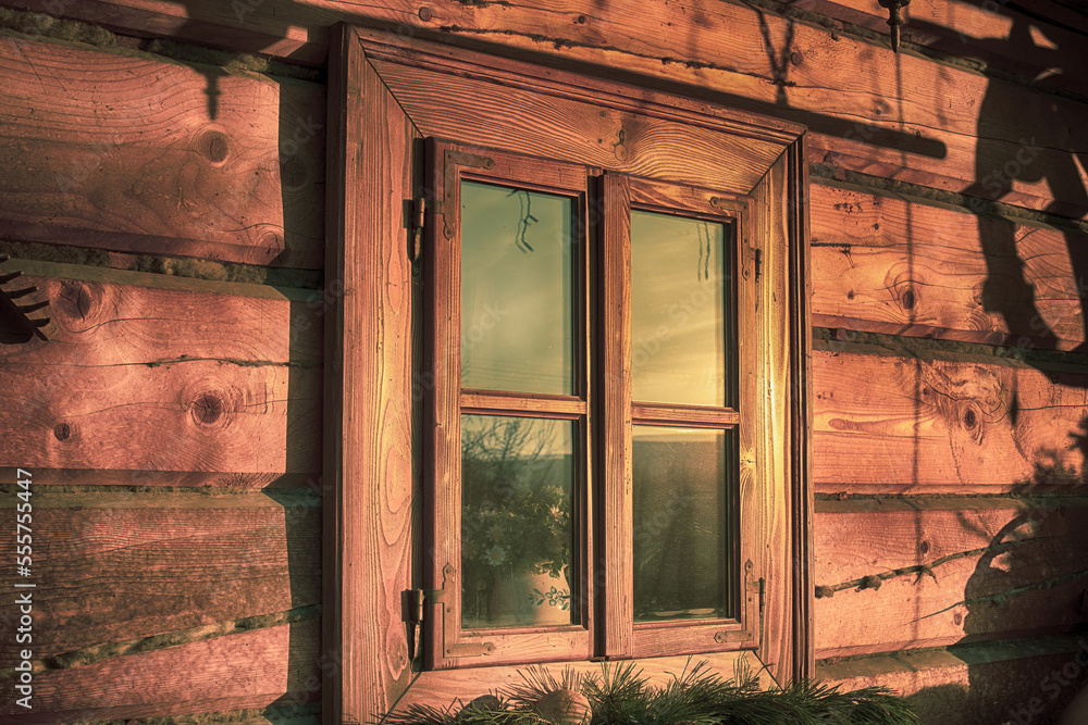 Window of a log house in early morning.Winter season.