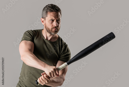 aggression of angry criminal man with bat in studio. photo of angry man hold bat.