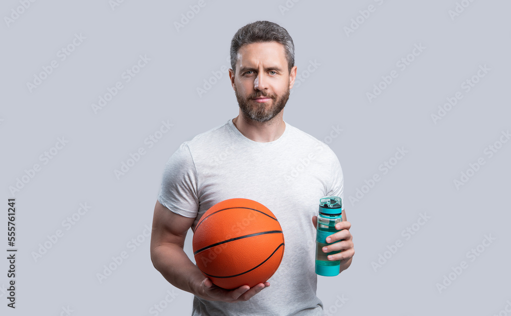 sport man basketball player drink water with ball. sport man basketball player in sportswear.