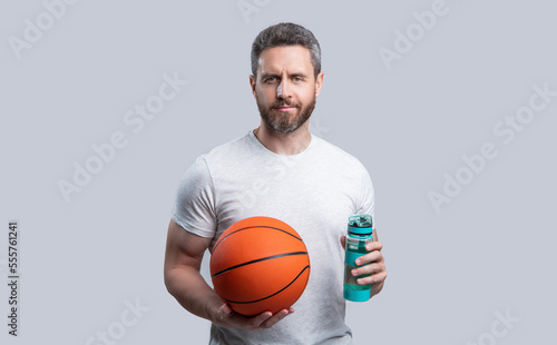 sport man basketball player drink water with ball. sport man basketball player in sportswear.