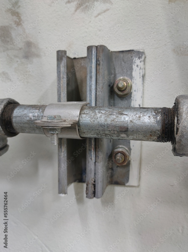 Conduit and clamp for cable electric ,Electrical Conduit with Clamp Installation on Roof ,Selective focus. Conduit and clamp for cable electric ,Electrical Conduit with Clamp Installation on Roof ,Selective focus.