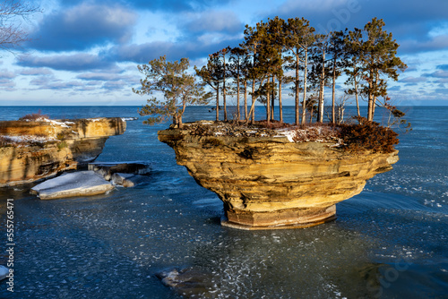 Morning sun lights up a rock formation on Lake Huron. Locally known as Turnip Rock, it is a popular destination for kayakers during the summer season. Pancake ice begins to form.