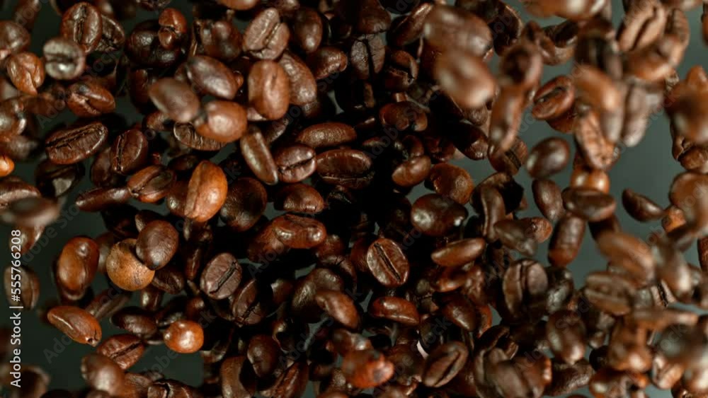 Super slow motion of rotating coffee beans on black background. Filmed on high speed cinema camera, 1000 fps placed on high speed cine bot. Camera moving up with rotation. Super slow motion of rotating coffee beans on black background. Filmed on high speed cinema camera, 1000 fps placed on high speed cine bot. Camera moving up with rotation.