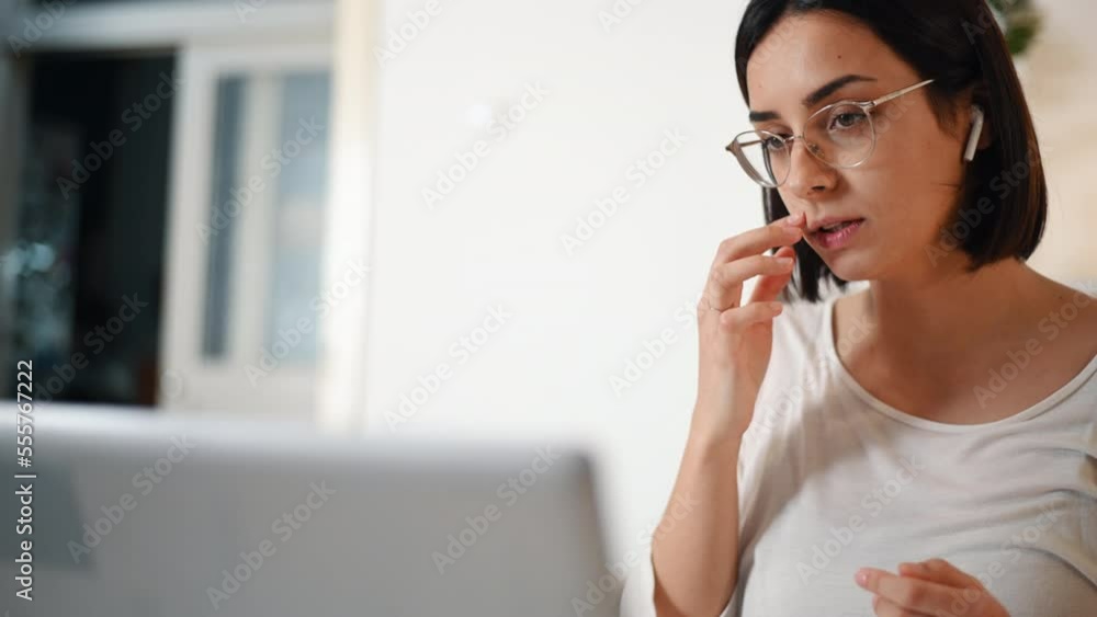 Young woman working on her laptop at home and having a online video call Young woman working on her laptop at home and having a online video call