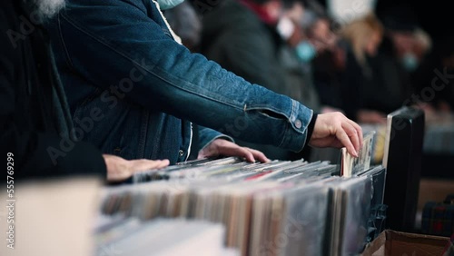 Close-up of a man hands choosing a vinyl at the vinyl market. photo