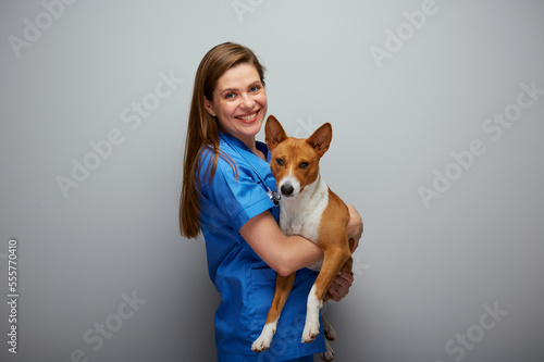Smiling veterinarian doctor holding dog Isolated portrait. photo