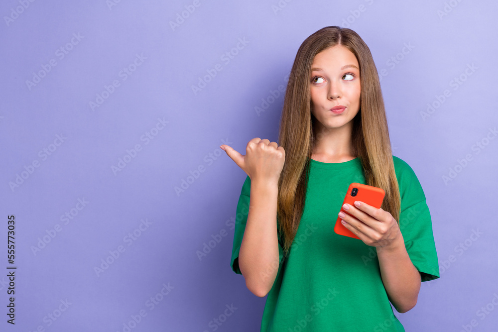 Photo of cute minded lady hand index empty space look offer proposition hmm dilemma want buy new device isolated on purple color background Photo of cute minded lady hand index empty space look offer proposition hmm dilemma want buy new device isolated on purple color background