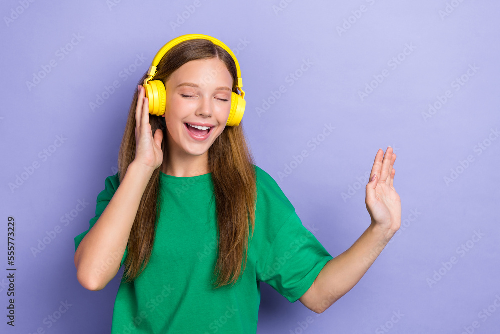Photo of cheerful cute lady wear green trendy clothes have fun chill relax rest empty space isolated on purple color background Photo of cheerful cute lady wear green trendy clothes have fun chill relax rest empty space isolated on purple color background
