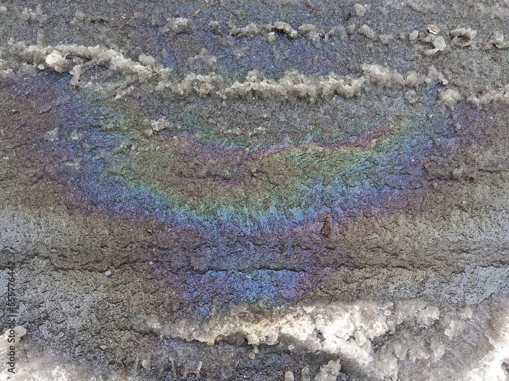 rainbow puddle of gasoline on the pavement
