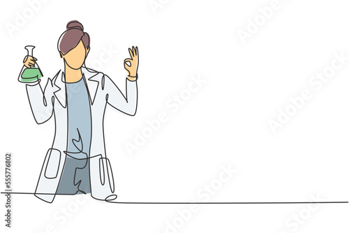Single continuous line drawing female scientist with gesture okay and holding measuring tube to examining chemical solution to make vaccine. Dynamic one line draw graphic design vector illustration