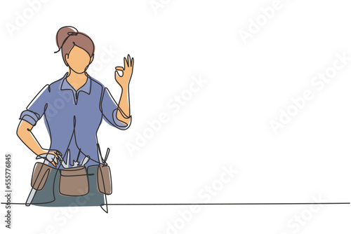 Continuous one line drawing handywoman with gesture okay ready to work on repairing the damaged part of house. Professional work. Success business. Single line draw design vector graphic illustration