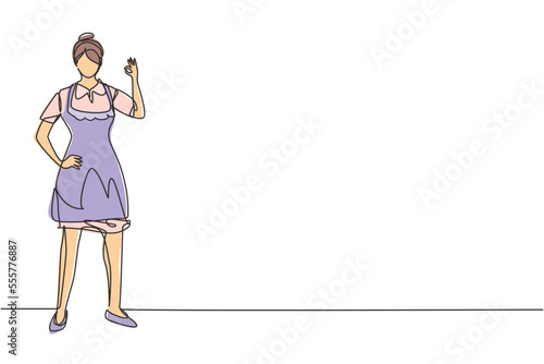 Single one line drawing maid in hotel stood with one hand on his waist and the other with gesture okay. Working with great hospitality. Modern continuous line draw design graphic vector illustration