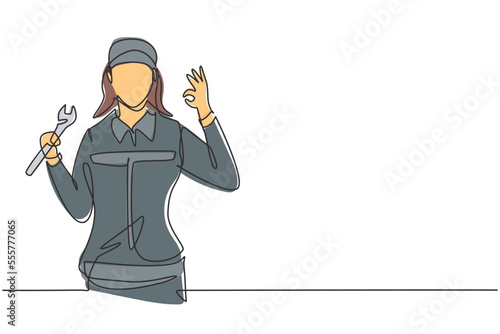 Continuous one line drawing female mechanic with gesture okay and holding wrench works to fix broken car engine in garage. Success business concept. Single line draw design vector graphic illustration