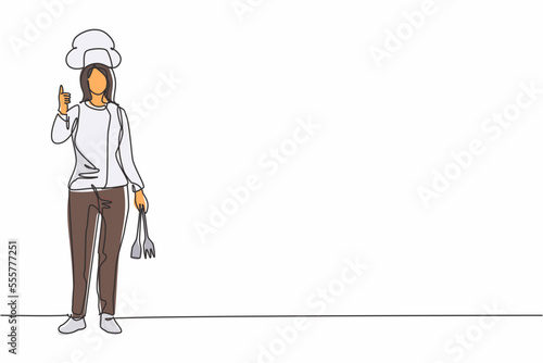 Single continuous line drawing female chef stands with a thumbs-up gesture and the cooking uniform prepares the ingredients to cook the best dishes. One line draw graphic design vector illustration