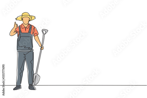 Single one line drawing of male farmer stood with a thumbs-up gesture, wearing a straw hat and carrying a shovel to plant crops on farmland. Continuous line draw design graphic vector illustration.