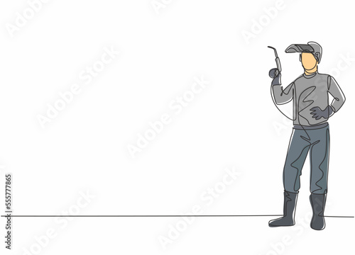 Continuous one line drawing of young male welder pose standing and holding a welding machine nozzle. Professional job profession minimalist concept. Single line draw design vector graphic illustration