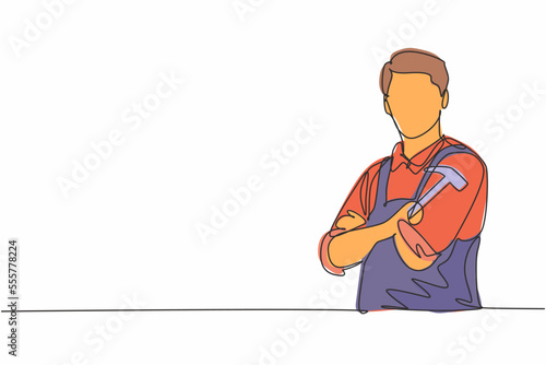 Single one line drawing young male carpenter cross arm on chest and holding hammer. Professional work profession and occupation minimal concept. Continuous line draw design graphic vector illustration