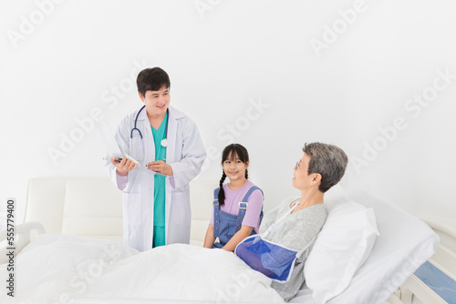 asian doctor talk with old patient in hospital  he screening and write patient information on patient chart  elderly healthcare treatment