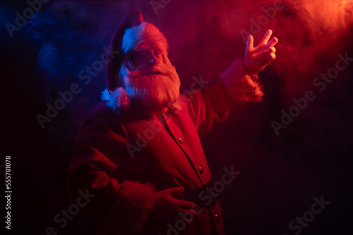 Santa Claus portrait in blue red neon light and smoke. 