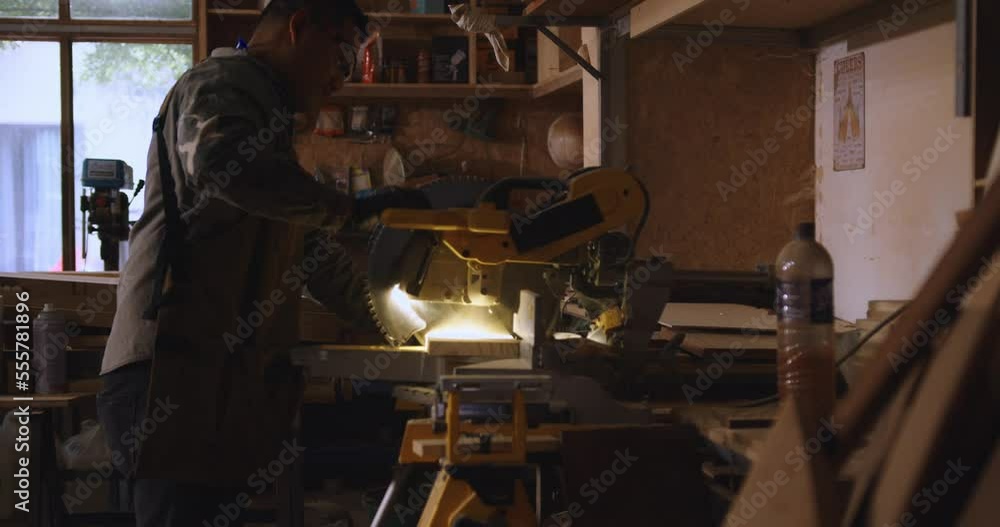 Asian carpenters are using wood-cutting tools in shops. Asian carpenters are using wood-cutting tools in shops.