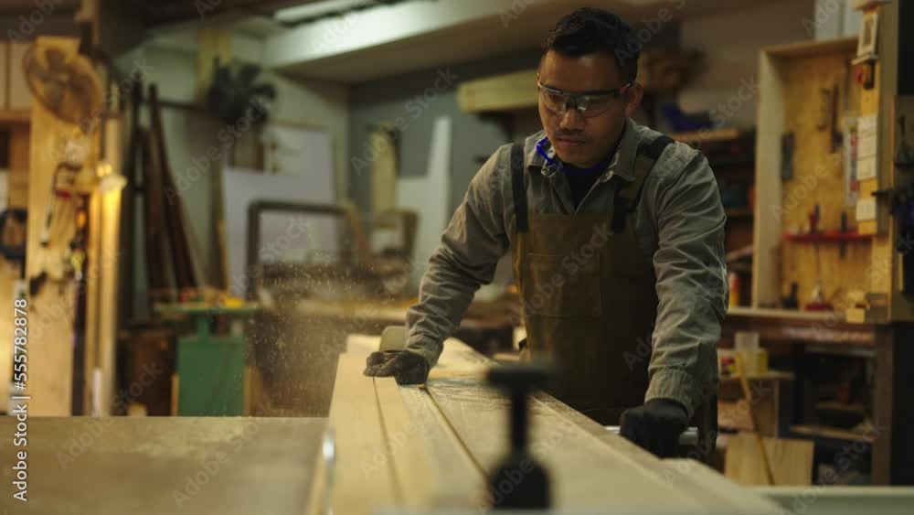 Asian carpenters are using wood-cutting tools in shops. Asian carpenters are using wood-cutting tools in shops.