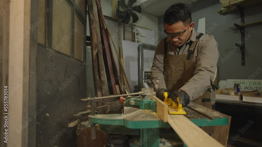 Asian carpenters are using wood-cutting tools in shops. Asian carpenters are using wood-cutting tools in shops.
