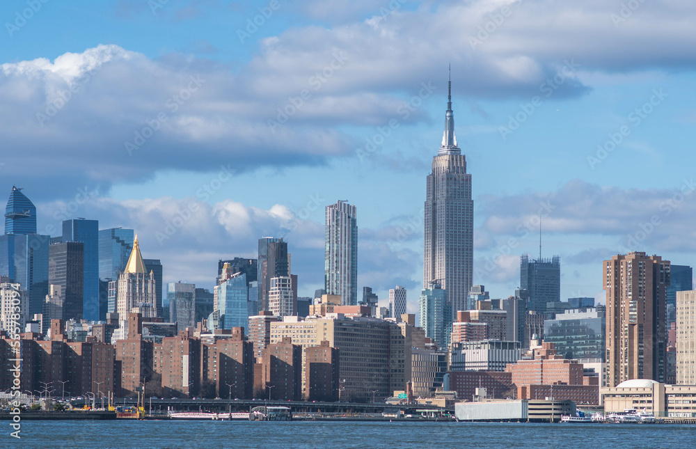 Obraz premium NYC Manhattan skyline buildings in a perfect daylight with clouds in the sky 