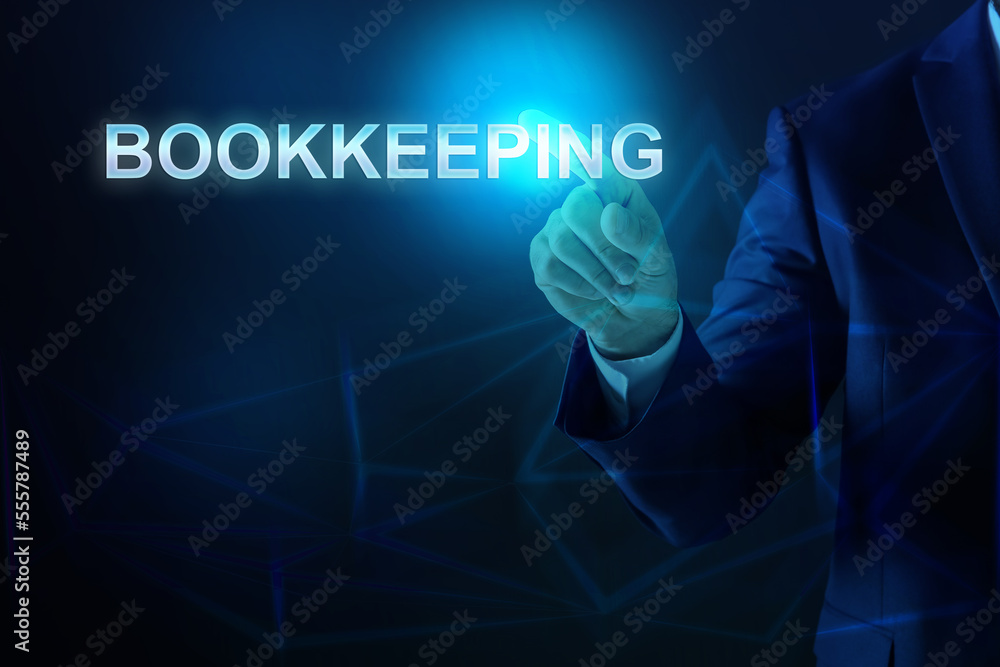 Bookkeeping concept. Businessman pointing at word on dark blue background, closeup Bookkeeping concept. Businessman pointing at word on dark blue background, closeup