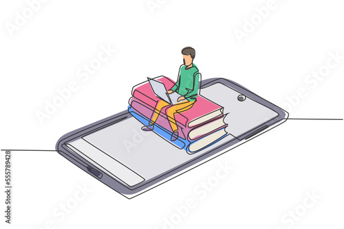 Single continuous line drawing male college student sitting on pile of books while typing on laptop on smartphone. Online education concept. Dynamic one line draw graphic design vector illustration
