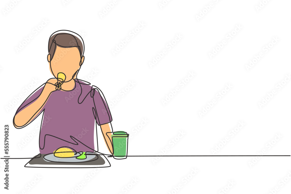 Single one line drawing young man having fruits meal with fork around table. Enjoy dessert at restaurant. Delicious and healthy food. Modern continuous line draw design graphic vector illustration