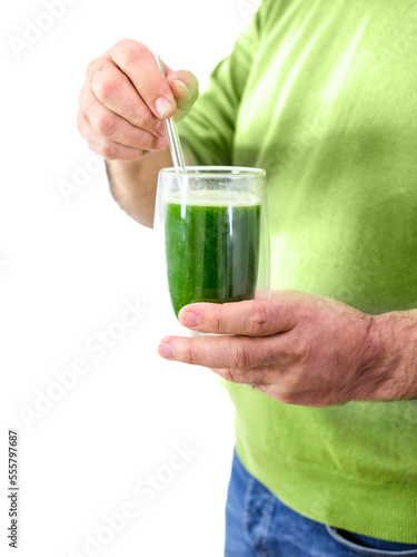 man holding a spirullina smoothie on a white background