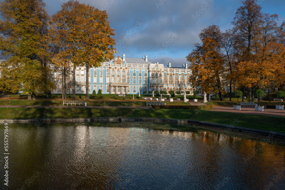 View of the Catherine Palace with a reflection in the Mirror Pond of the Catherine Park in Tsarskoye Selo on a sunny autumn day, Pushkin, Saint Petersburg, Russia View of the Catherine Palace with a reflection in the Mirror Pond of the Catherine Park in Tsarskoye Selo on a sunny autumn day, Pushkin, Saint Petersburg, Russia