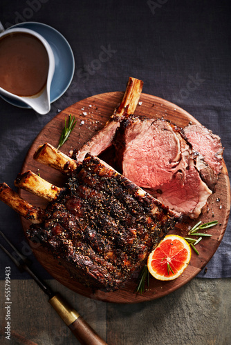 Citrus and rib roast on a wooden cutting board photo