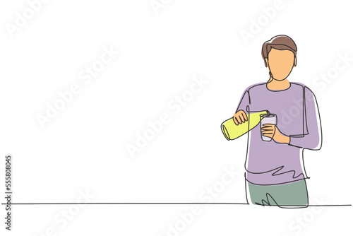 Single continuous line drawing handsome male pouring orange juice into glass from bottle while having breakfast at home. Healthy lifestyle concept. One line draw graphic design vector illustration