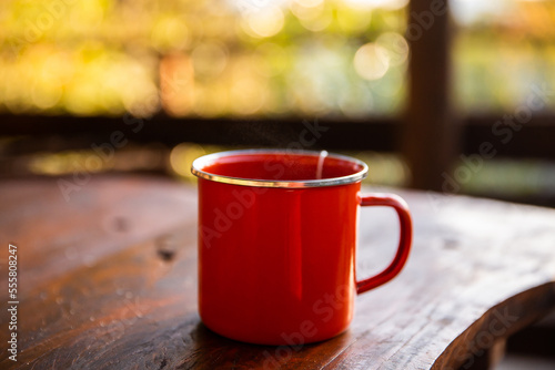 orange enamel cup in morning light photo