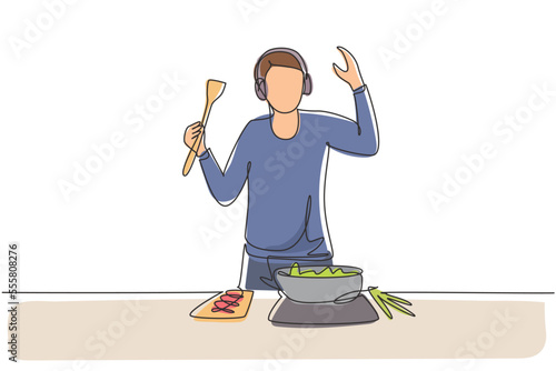 Single one line drawing young man cooking and listening to music in kitchen. Healthy food illustration. Healthy lifestyle concept. Cooking at home. Prepare food. Continuous line draw design graphic