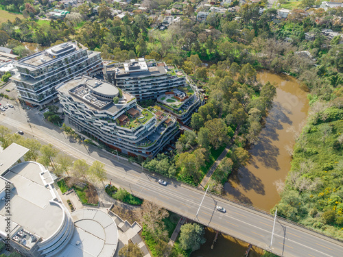 Aerial view of apartments complexes near a major road and a river bend