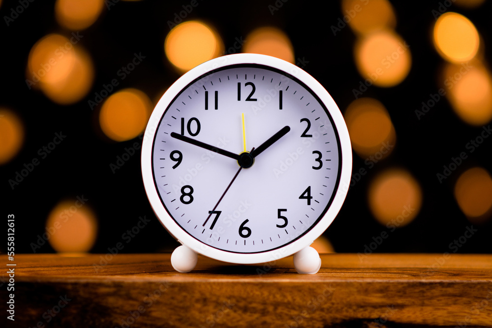 White clock isolated on bokeh lights background White clock isolated on bokeh lights background