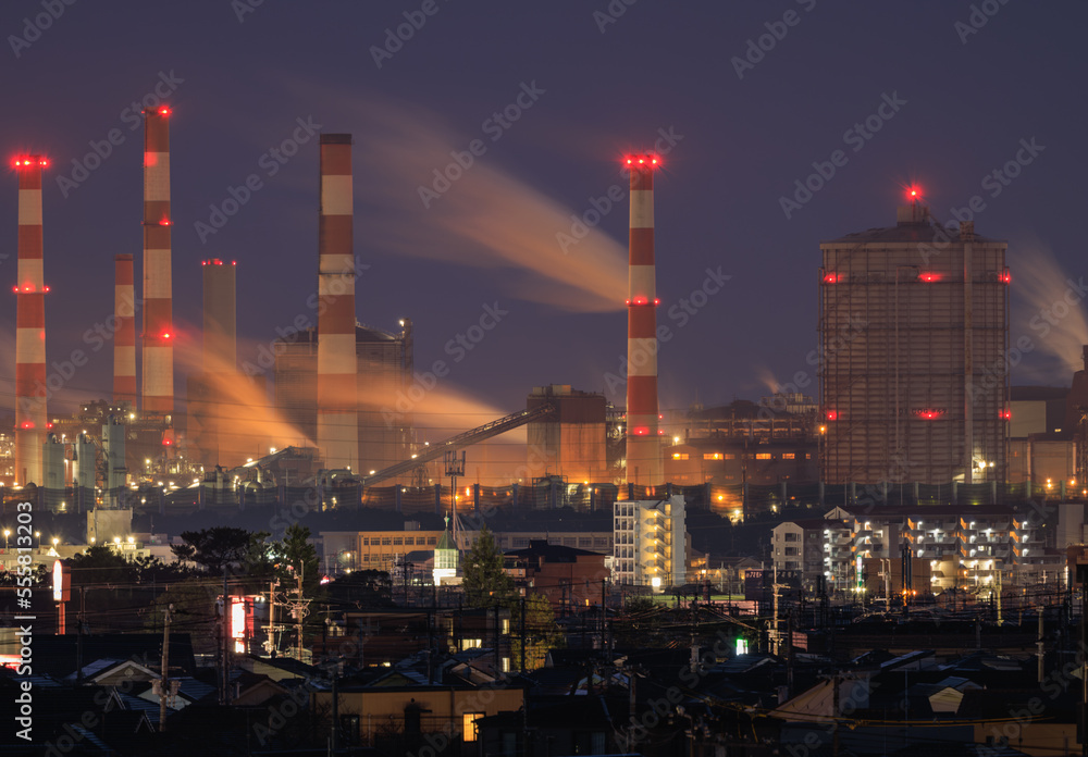 Gas from industrial plant next to residential neighborhood at night
