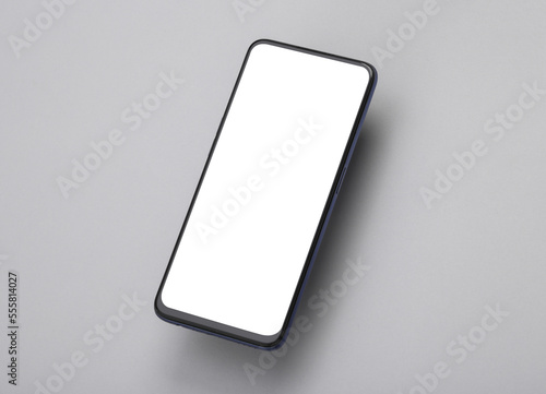 Mockup of a levitating smartphone with a white screen on a gray background