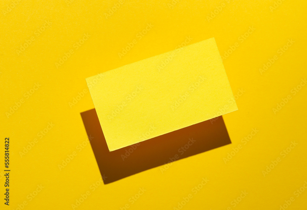 Yelow Blank business card for corporate identity with shadow on yellow background. Creative mockup. Yelow Blank business card for corporate identity with shadow on yellow background. Creative mockup.