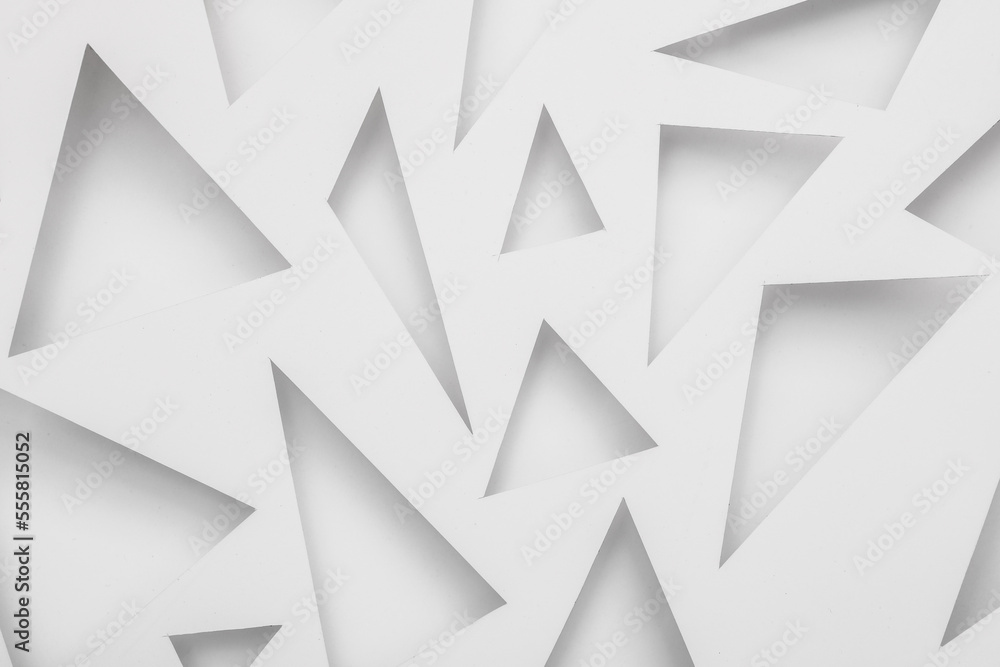 Cut paper in the shape of triangles. Abstract white background Cut paper in the shape of triangles. Abstract white background
