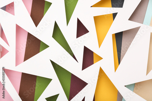 Cut paper in the shape of triangles. Abstract background