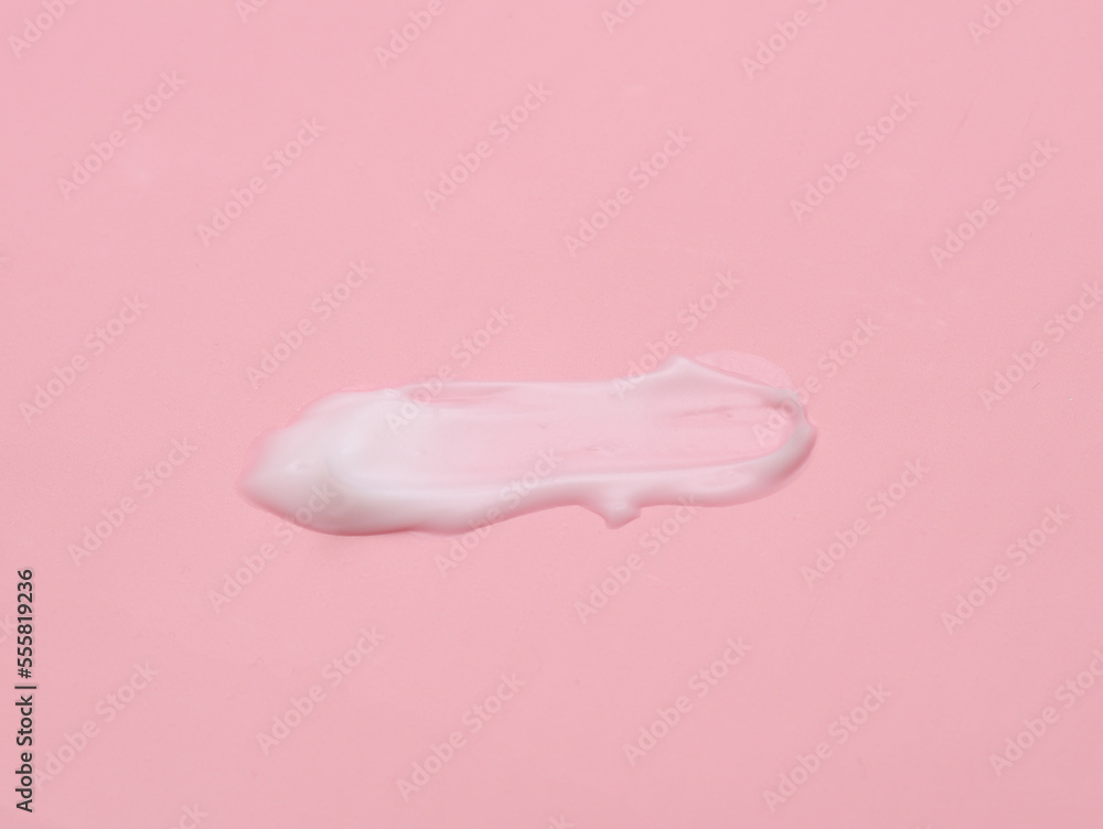 Liquid cream cosmetic stain texture on pink background Liquid cream cosmetic stain texture on pink background