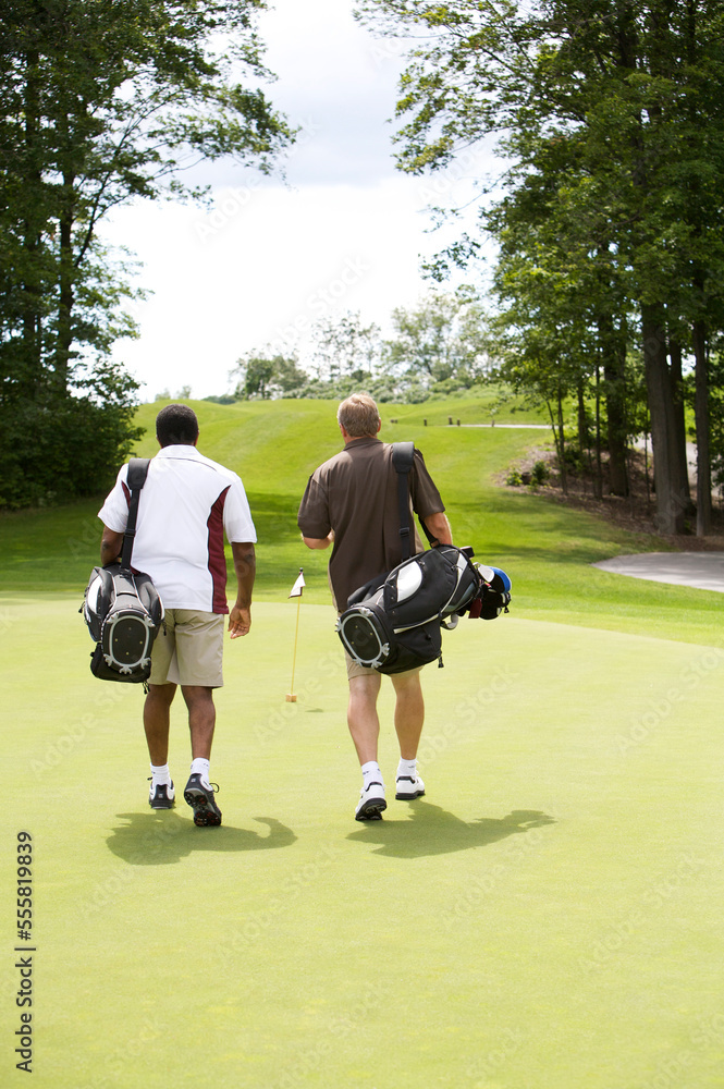 Men Walking on Golf Course, Burlington, Ontario, Canada Men Walking on Golf Course, Burlington, Ontario, Canada